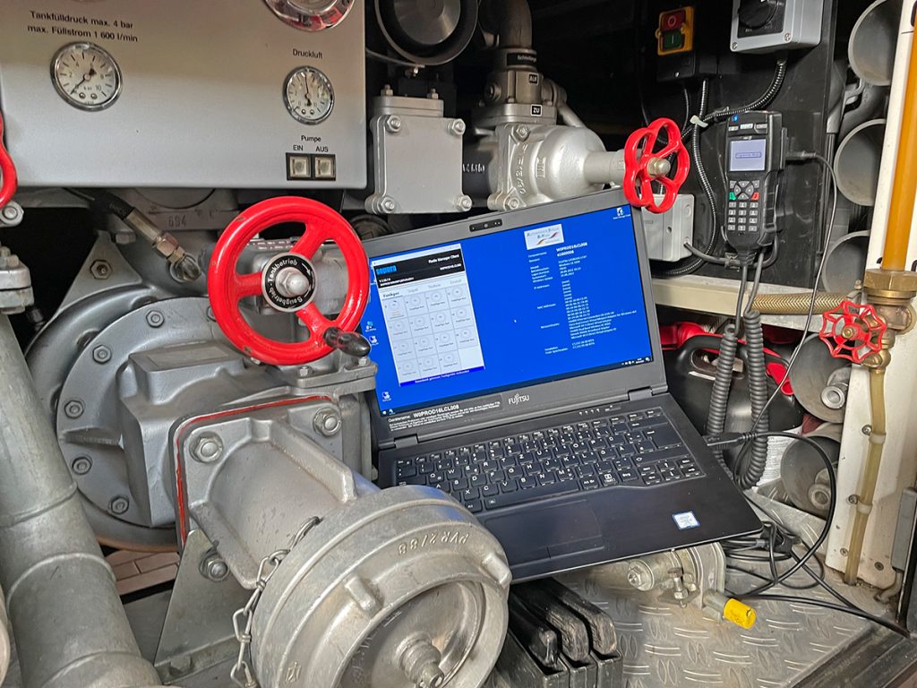 Aufspielen des Updates - Laptop und Digitalfunkgerät im Maschinenbereich eines Feuerwehrfahrzeuges